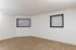 Two-window bedroom at Timbers Apartments offering natural lighting and a quiet living space in downtown Springfield.