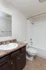 Full bathroom at Timbers Apartments in downtown Springfield, MO, showcasing a combination tub and shower, vanity with marble-look countertop, and modern fixtures.
