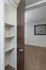 Bedroom entrance view at Timbers Apartments featuring built-in shelving and large window for natural light.