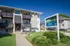 Front of Timbers Apartments with property signage, landscaped entrance, and leasing information.