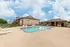 Spacious community pool with multiple lounge chairs, ample deck space, and surrounding apartment buildings&mdash;ideal for gatherings and sunbathing.