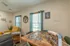Puzzle table setup in the Republic Palms community space with natural light streaming through teal-draped windows, offering a cozy resident activity area.