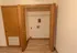 Closet with in-unit washer and dryer hookups in a Polo Club apartment, featuring folding doors and a storage shelf.