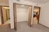 Walk-in closet in a Polo Club apartment with built-in wire shelving and direct access to the bathroom and bedroom.