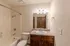Bathroom in Polo Club apartments featuring updated lighting fixtures, a granite-style vanity, and a spacious shower and tub combo.