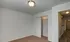 Carpeted bedroom with sliding closet doors and open hallway access at Embassy Ozark Apartments.