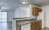 Granite-style countertops, dual sink, and raised breakfast bar in a bright Embassy Ozark kitchen.
