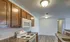View of white electric stove and built-in microwave surrounded by warm-toned cabinetry and durable countertops.