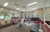 On-site fitness center at Cobblestone Village with treadmills, recumbent bikes, and mirrors, designed to support health and wellness for 55+ community residents.