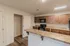 Functional kitchen at Republic Palms Apartments in Republic, MO, featuring speckled countertops, a breakfast bar, ample cabinet storage, and a pantry closet with wire shelving.