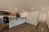 Open kitchen at Republic Palms Apartments in Republic, MO, with a breakfast bar leading into a hallway with storage closets and access to the bathroom and bedrooms.