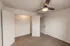 Bedroom with open closet &ndash; Spacious bedroom at Republic Palms Apartments in Republic, MO, featuring a wide closet with wire shelving, soft carpet, and a ceiling fan for comfort.