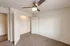 Bedroom with open closet and shelving &ndash; Light-filled bedroom at Republic Palms Apartments in Republic, MO, with carpet flooring, ceiling fan, and a wide closet with built-in wire shelving.