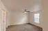 Bedroom with ceiling fan and window &ndash; Bright bedroom at Republic Palms Apartments in Republic, MO, featuring plush carpet, a ceiling fan with light, and a large window with blinds.