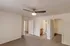 Bedroom with open walk-in closet &ndash; Bedroom at Republic Palms Apartments in Republic, MO, showcasing plush carpet, a ceiling fan, and a spacious walk-in closet with wire shelving.