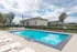 Inviting outdoor pool area with comfortable lounge chairs, perfect for relaxation and leisure in a serene residential setting.