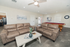 Inviting living room with plush sofas, modern decor, and a billiards table, perfect for relaxation and entertaining.