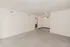 Spacious open concept living and dining area with neutral carpet, wood style flooring, and a ceiling fan.