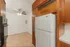 Charming kitchen with a cozy, open area, featuring wood cabinets and modern appliances.