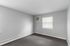 Bright and inviting room with neutral tones, equipped with air conditioning and large window, ideal for customization.