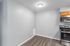 Modern kitchen area with sleek stainless steel appliances and elegant wood floors, perfect for creating culinary delights.