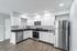 Modern kitchen with sleek stainless steel appliances, elegant white cabinetry, and spacious countertops, offering a stylish and functional cooking space.