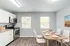 Modern kitchen with stainless steel appliances, elegant dining area, and bright natural light.