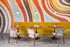 Yellow banquet, swirly orange, yellow, blue, and brown wallcovering