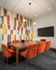 wood board room table with orange suede chairs