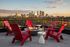 red adirondack chairs around fire pit, Minneapolis skyline in background