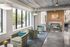 swivel chairs and bench, floor to ceiling fireplace with colorful art
