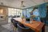wood board room table with navy chairs and blue and green wall covering