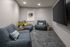 small room with oversized comfy chairs with tv mounted on wall