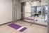 wall to wall mirror, purple yoga mat on the ground