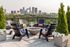 black adirondack chairs around fire pit, Minneapolis skyline in background