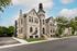 Charming historic stone building with modern amenities, featuring elegant Gothic architecture and lush greenery, perfect for stylish living.