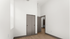 Bright and spacious room with elegant hardwood flooring and sliding closet doors, perfect for a modern minimalist style.