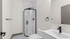 Elegant bathroom featuring a modern glass shower, a sleek white vanity, and minimalist black fixtures.