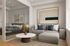 Modern living space with elegant grey sectional sofa, abstract wall art, and a serene bedroom view through glass partition.