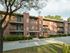 Red brick residential apartment building with private balconies