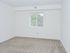 Bedroom with beige carpet and a window at Gladstone Towers apartments for rent in Lansdowne, PA