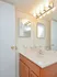 Spacious master bathroom with overhead lighting and large mirror