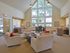 Community lounge with mixed seating areas with tables and chairs at Park City apartments in Lancaster, PA.