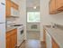 Model kitchen with wood cabinets and modern appliances at Park City apartments in Lancaster, PA.