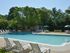 Swimming pool with lounge chairs at Rolling Glen Townhomes and Apartments in Boothwyn, PA.