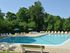 Swimming pool with lounge chairs at Rolling Glen Townhomes and Apartments in Boothwyn, PA.
