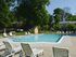 Swimming pool with lounge chairs at Rolling Glen Townhomes and Apartments in Boothwyn, PA.