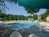 Swimming pool with lounge chairs and umbrellas at Rolling Glen Townhomes and Apartments in Boothwyn, PA.