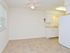 Model dining area with ceiling fan looking into the kitchen at Rolling Glen Townhomes and Apartments in Boothwyn, PA.