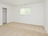 Carpeted model bedroom with closet at Rolling Glen Townhomes and Apartments in Boothwyn, PA.